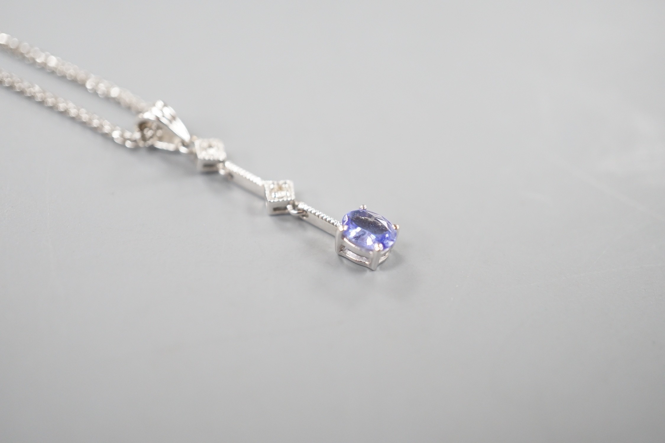 A modern Italian 705 white metal tanzanite and diamond set three stone pendant necklace, 48cm, gross weight 4 grams.